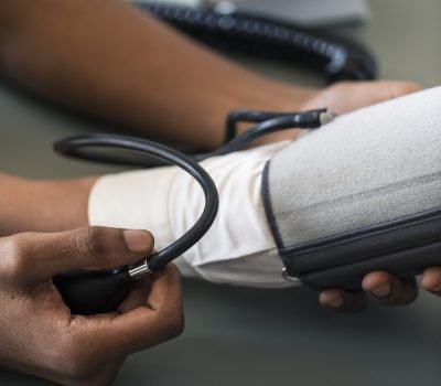 Nurse measuring patient blood pressure